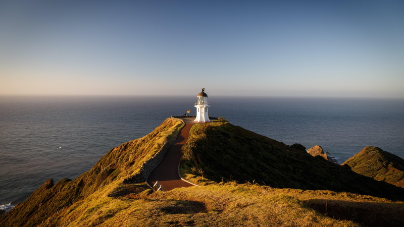 blue sky, architecture, sea, building exterior, built structure, cape, land, lighthouse, vacations, ocean, horizon, coast, direction, clear sky, scenics - nature