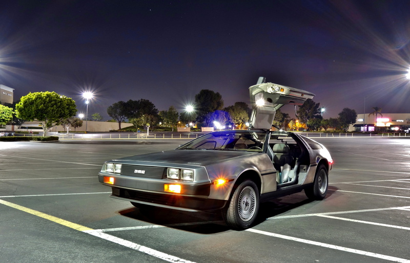 land vehicle, motion, parking lot, delorean, sign, automotive, road marking, blurred motion, car, asphalt, time machine, road, night, transportation, no people