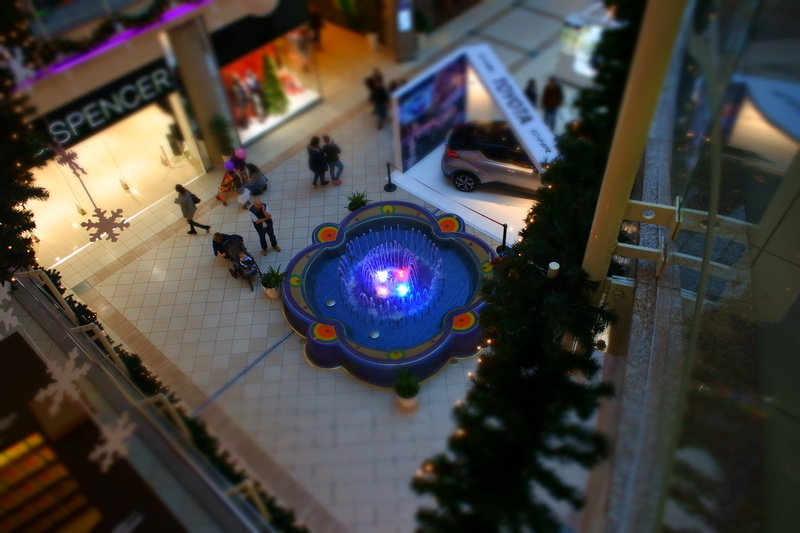 people, building exterior, mall, commercial building, department store, high angle shot, city, auto show, selective focus, indoors, lighting equipment