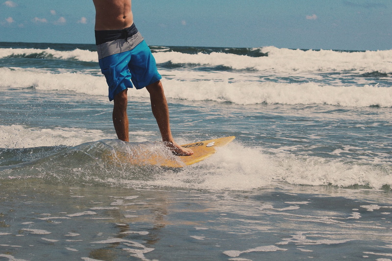 sport, board shorts, surfboard, blue board, water, outdoors, aquatic sport, splashing, wave, nature, man, summer, real people, leisure activity, surf, skimboard