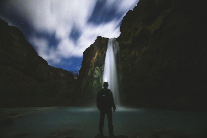 water, dark, land, night, nature, waterfalls, beauty in nature, front, river, sky, cloud - sky, men, outdoors, man, real people, rear view, clouds, one person