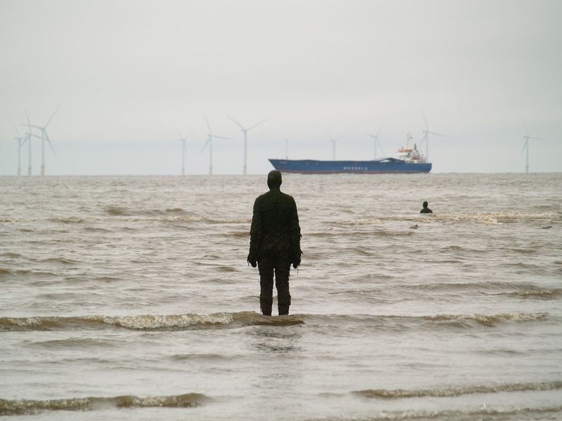 rear view, outdoors, turbine, sky, one person, crosby, water, horizon over water, transportation, sculpture, alternative energy, renewable energy, coastline