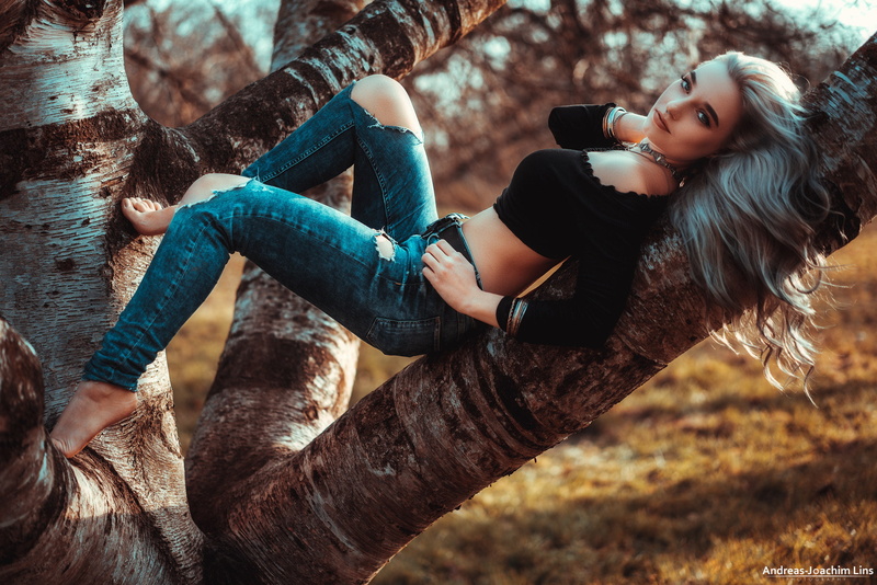 women outdoors, depth of field, one person, day, trees, beautiful woman, women, young adult, lifestyles, casual clothing, sitting, forest, land, portrait