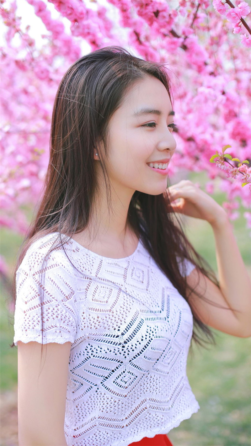 long hair, positive emotion, beautiful woman, brunette, one person, brown hair, flowering plant, pink color, waist up, hairstyle, hair, sakura (tree), happiness