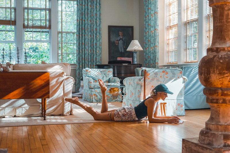 white, wooden floor, living room, blue, female, glass, window, floor, model, hairstyle, technology, woman, furniture, sunlight, indoors, adult, pose, fashion
