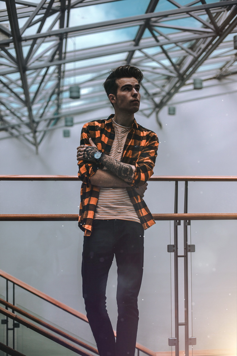 lifestyles, building, metal, handrails, sideways, glass, standing, three quarter length, young men, nature, wear, architecture, outdoors, looking, blue sky