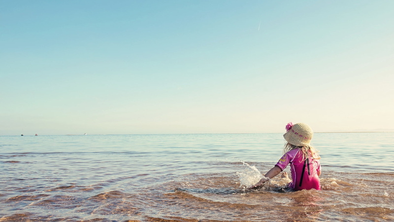 caucasian Ethnicity, cheerful, cute, horizon over water, sunlight, blue, top, lifestyles, joy, girl, copy space, s, rear view, clear sky, beach, real people