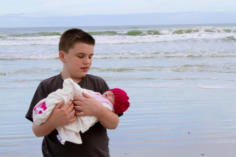 leisure activity, males, newborn, sea, casual clothing, small, family, happy, carrying, horizon over water, boy, infant, one person, child, landscape, pre-adolescent child