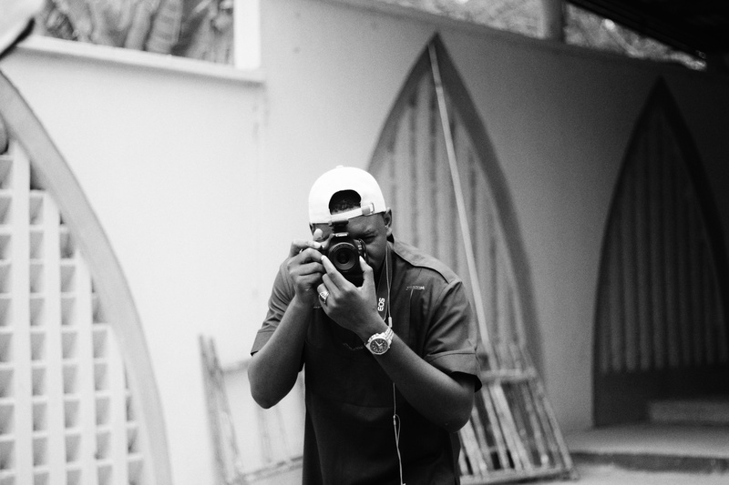student, camera, canon, electronics, adult, obscured face, noir, photographic equipment, occupation, squint, holding, digital camera, man, person, architecture