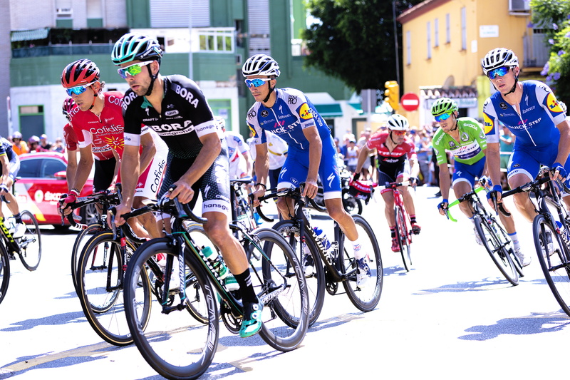 bicycle, competition, riding, potted plant, street, person, el palo, activity, cycling race, transportation, sports clothing, group of people, cycling