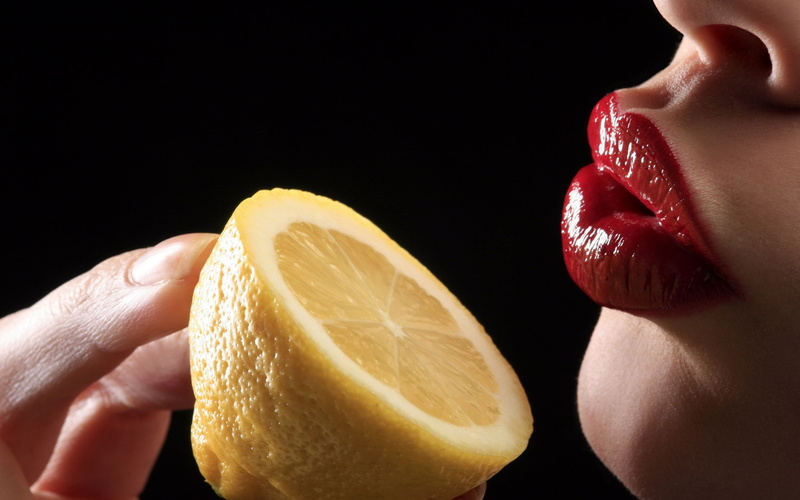 adult, lemon, fruit, indoors, food, black background, body part, human mouth, mouth, women, beautiful woman, human face, food and drink, lemons, slice