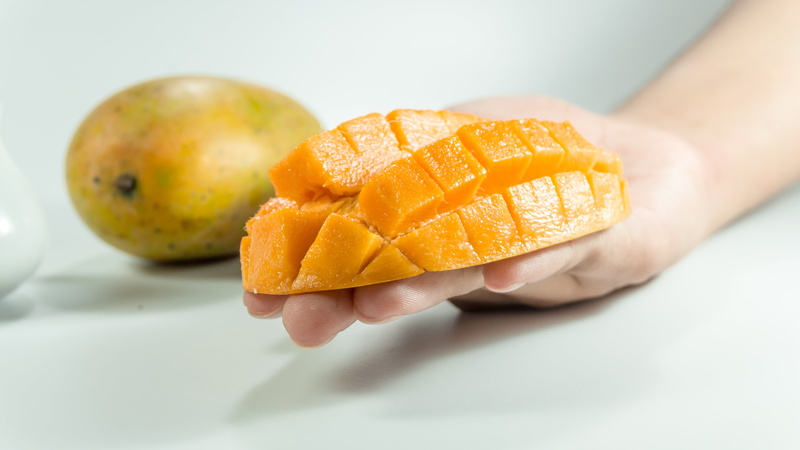 fresh, mango fruit, sliced, human hand, organic, isolated, healthy eating, adult, orange, gourmet, fruit, juicy, yellow, background, dieting, indoors, slice