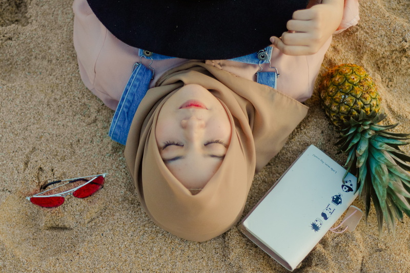 hijab, field, holding, person, nature, publication, front view, relaxation, communication, woman, pineapple, adult, women, lying, lying down, high angle view