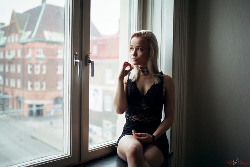 window, transparent, wireless technology, glass - material, real people, black, casual clothing, choker, one person, portrait, blonde, looking, beautiful woman