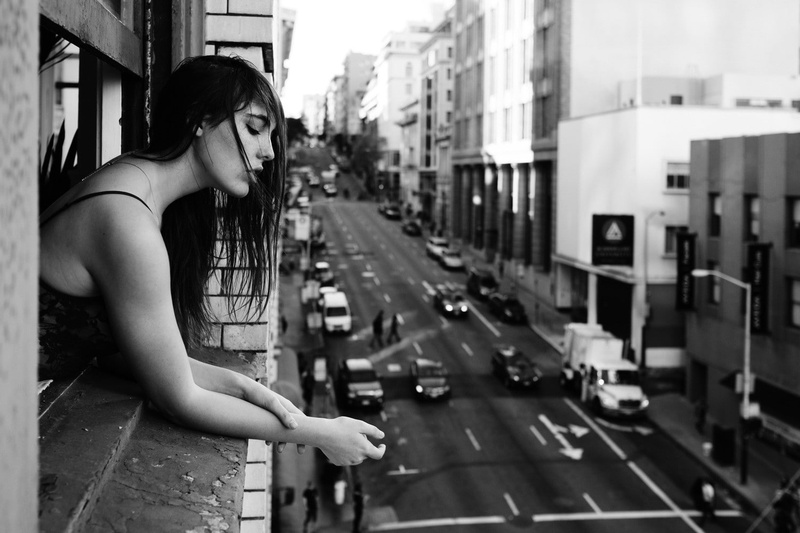 day, monochrome, city, real people, incidental people, young adult, outdoors, 720P, mode of transportation, side view, looking away, lifestyles, focus on foreground
