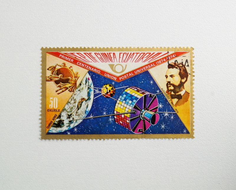 guinea, the past, affix, indoors, postage stamp, white background, flag, compendiums, postmark, human representation, collect, shape, old-fashioned, franking