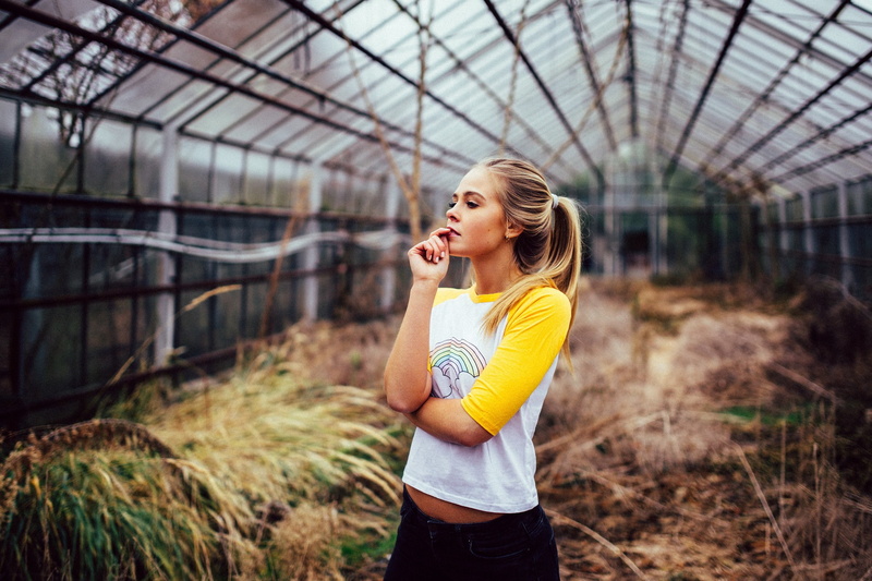 ponytail, long hair, women, side view, looking away, beautiful woman, hair, day, one person, focus on foreground, standing, outdoors, brunette, finger on lips