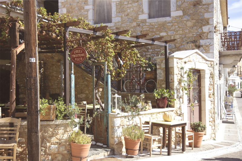 courtyard, greek, cafe, gray, building exterior, tables, outdoors, seat, chair, restaurant, text, lantern, potted plant, concrete, chairs, fence, plant