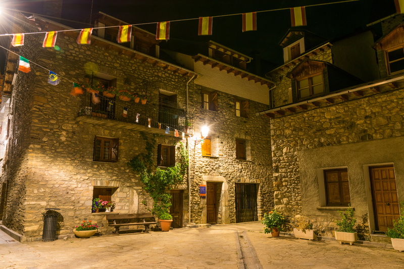 light, night, wall, built structure, direction, architecture, transportation, potted plant, outdoors, fiesta, abandoned, street, banderitas, flower pots