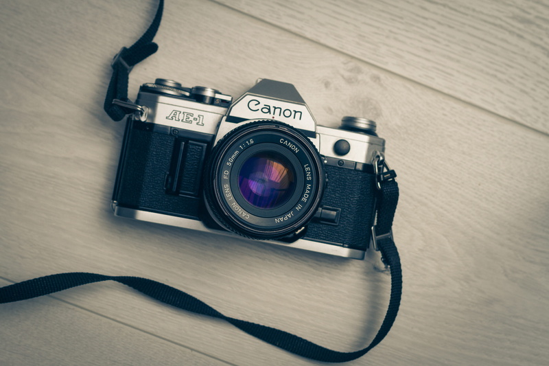 milc, text, indoors, photographing, film camera, film, home video camera, still life, photographic equipment, activity, table, photography, vintage camera