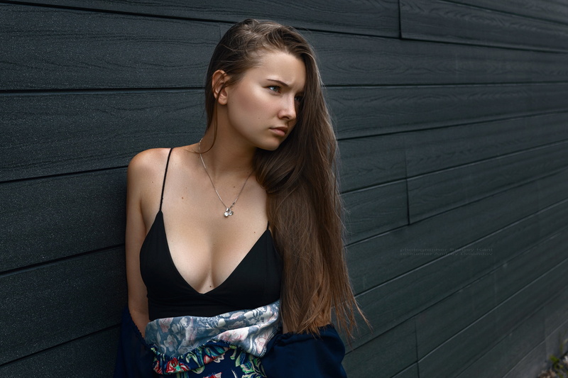 model, brown hair, standing, young adult, black tops, women outdoors, outdoors, lifestyles, looking into the distance, fashion, contemplation, one person
