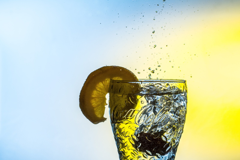 drinking Glass, coca cola, water, copy space, nature, motion, household equipment, wet, refreshing, splashing, no people, yellow, coke, refreshment, colored background