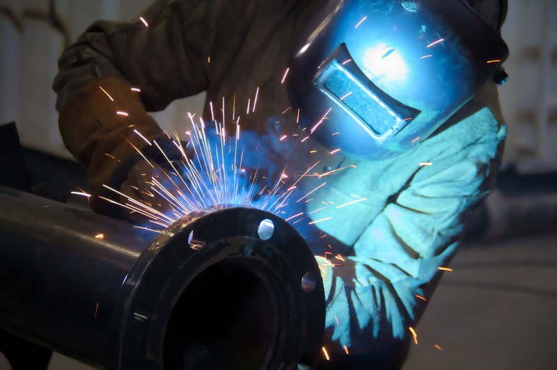 working, indoors, metal industry, protection, one person, work, illuminated, industry, sparks, man, skill, mask, holding, welding, motion, security, protective workwear
