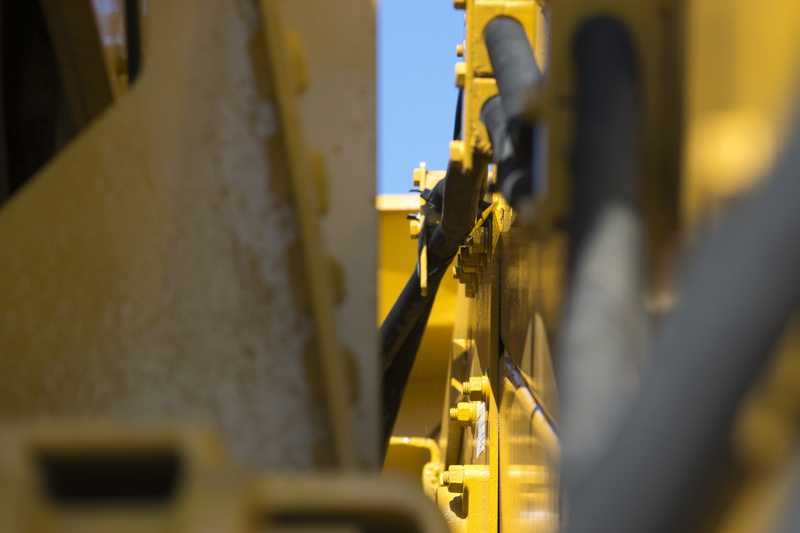 machinery, indoors, in a row, machine part, production line, excavator, industrial equipment, yellow, manufacturing equipment, machine, factory, business