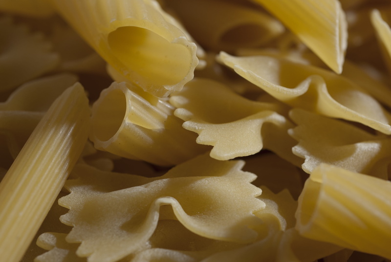 cooking, indoors, yellow, pasta, raw food, close-up, spaghetti, food processing plant, no people, preparation, desktop, food and drink, snack, shape, large group of objects