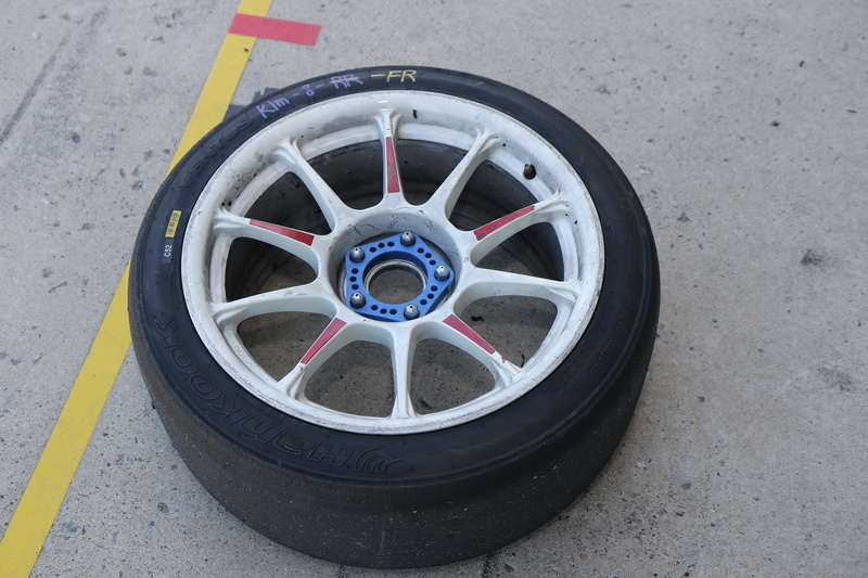 vehicle part, outdoors, 5K, auto sports, sports cars, motor sports, circle, race tires, no people, car, metal, street, lace, high angle view, motor vehicle