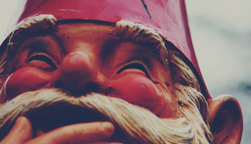 sculpture, statue, smiling, focus on foreground, body part, closeup, outdoors, one person, art and craft, close-up, gnomes, real people, human face, food and drink