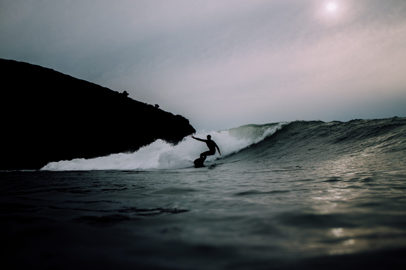 water, silhouette, wave, aquatic sport, sky, sport, scenics - nature, cliff, leisure activity, 5K, nature, surfing, outdoors, rock, motion, conquering adversity