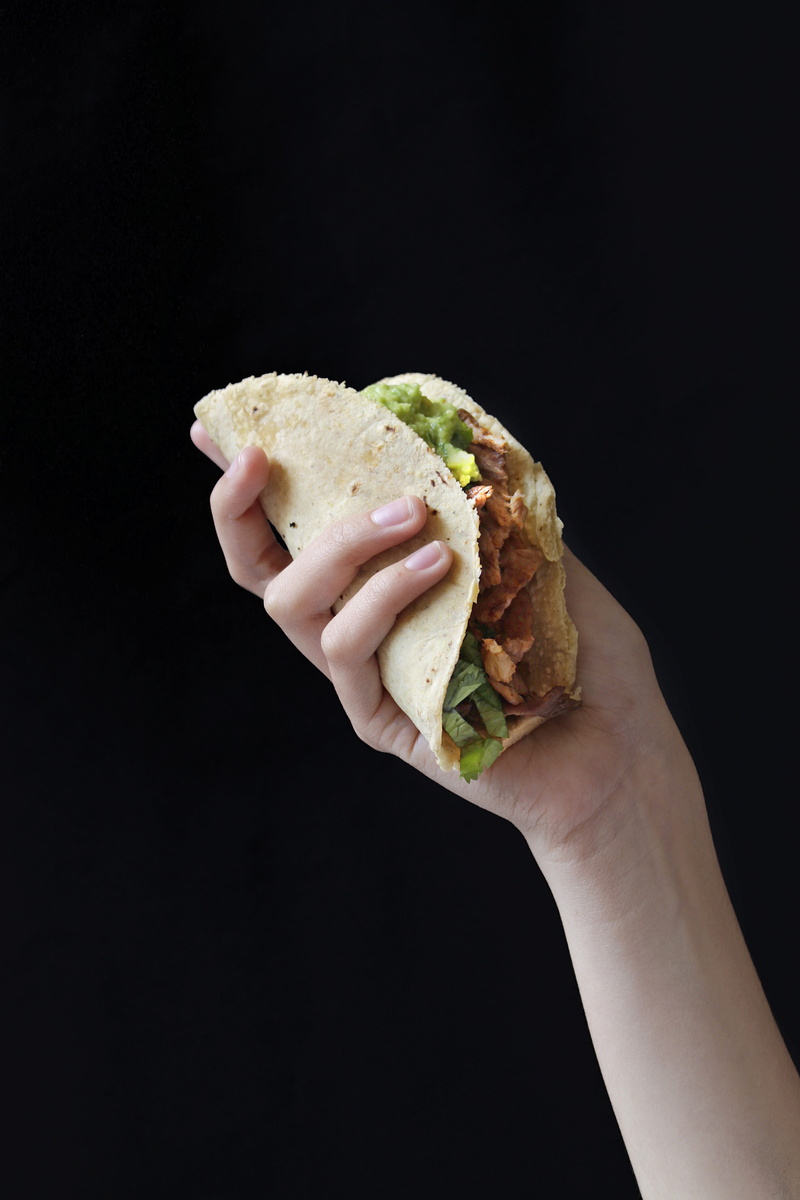 ready-to-eat, black background, cheeseburger, fast food, one person, meat, hand, holding, indoors, food and drink, bread, hungry, take out food, vegetable