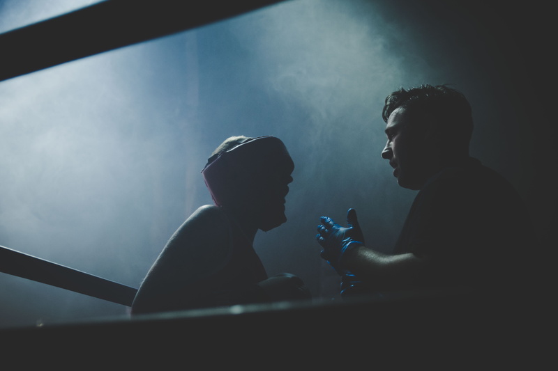people, inside, illuminated, crowd, leisure activity, boxing, smoke, arts culture and entertainment, two, men, sitting, silhouette, indoors, tough, lifestyles