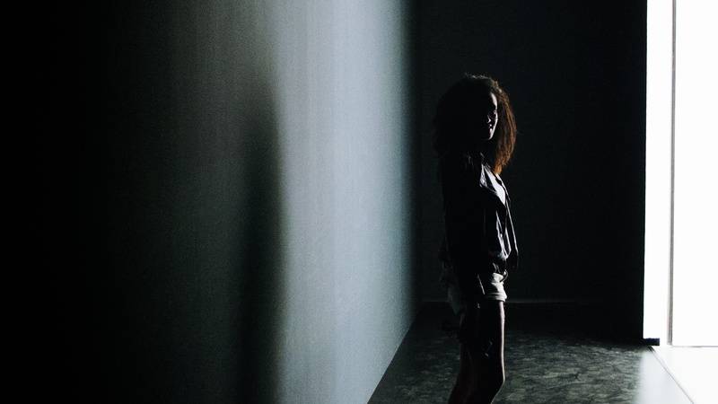 strong, internationals women day, leisure activities, shadow, wall - building feature, looking, profile view, fashion, long sleeve, real people, casual clothing
