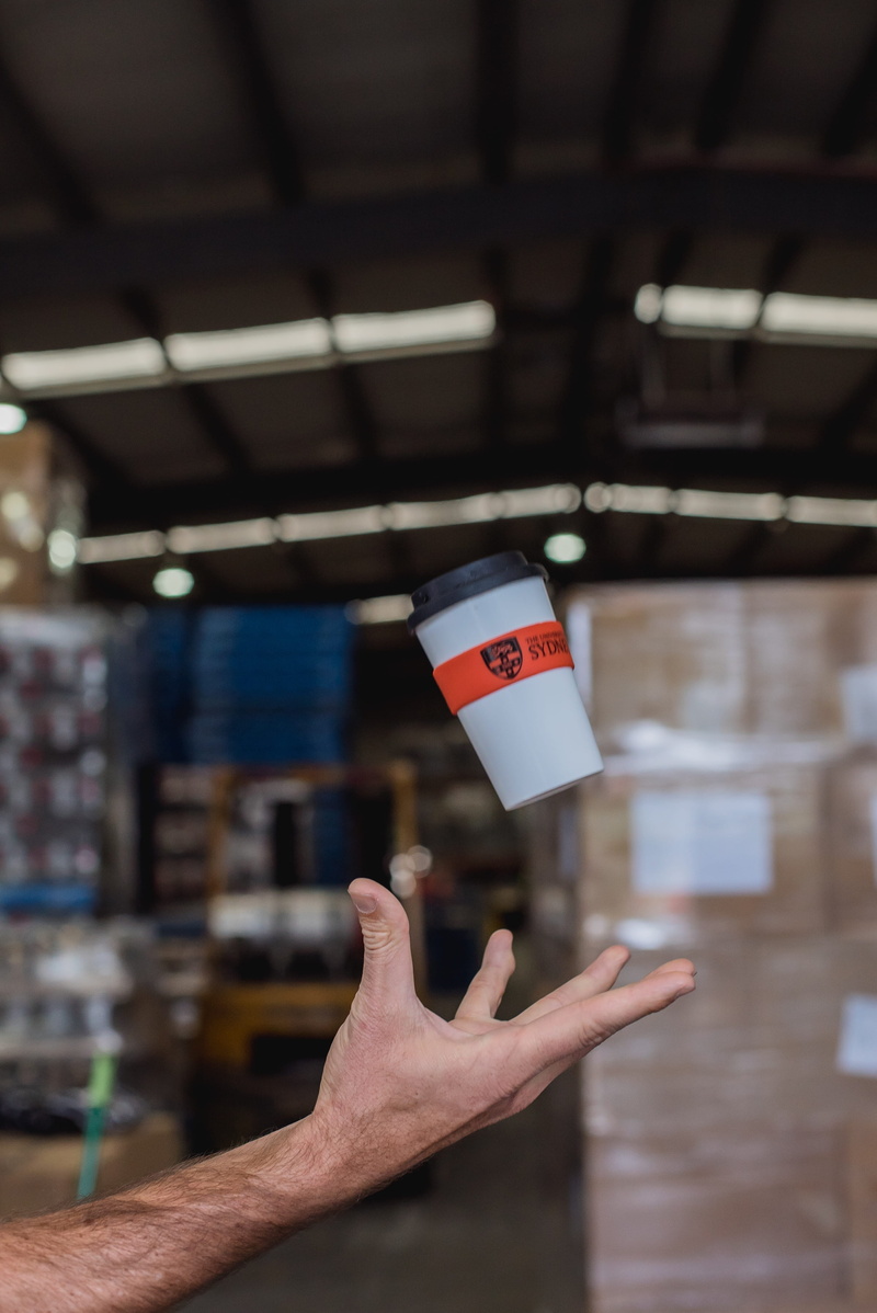 unrecognizable person, communication, indoors, reusable coffee cup, democracy, reusable cup, body part, holding, one person, carton, person, human body part