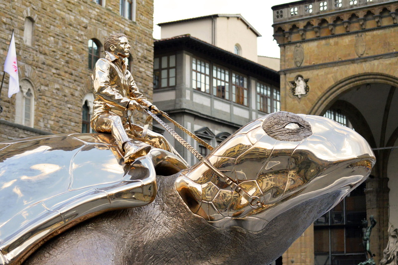 motor vehicle, mode of transportation, transportation, turtle, enormous, huge, human representation, chrome, day, riding, creativity, building exterior