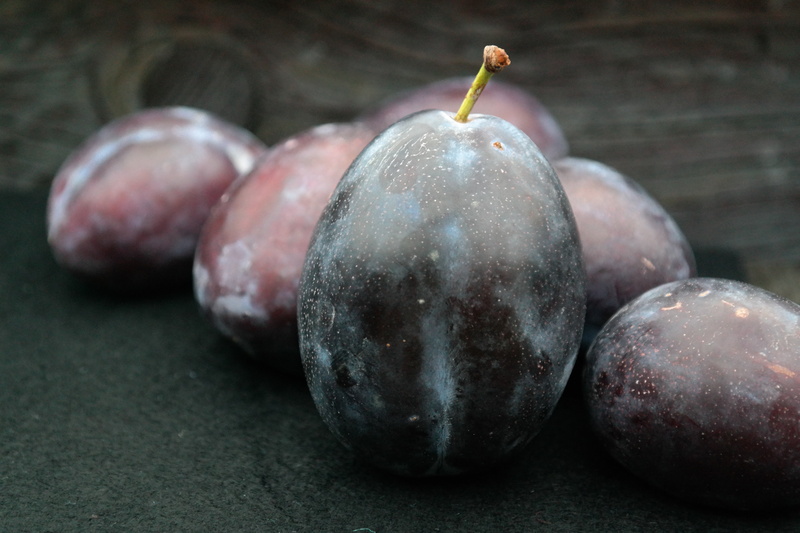 fruit, plum, prunus domestica subsp domestica, no people, fig, blue black, table, group of objects, freshness, large, snack, food, indoors, violet, focus on foreground