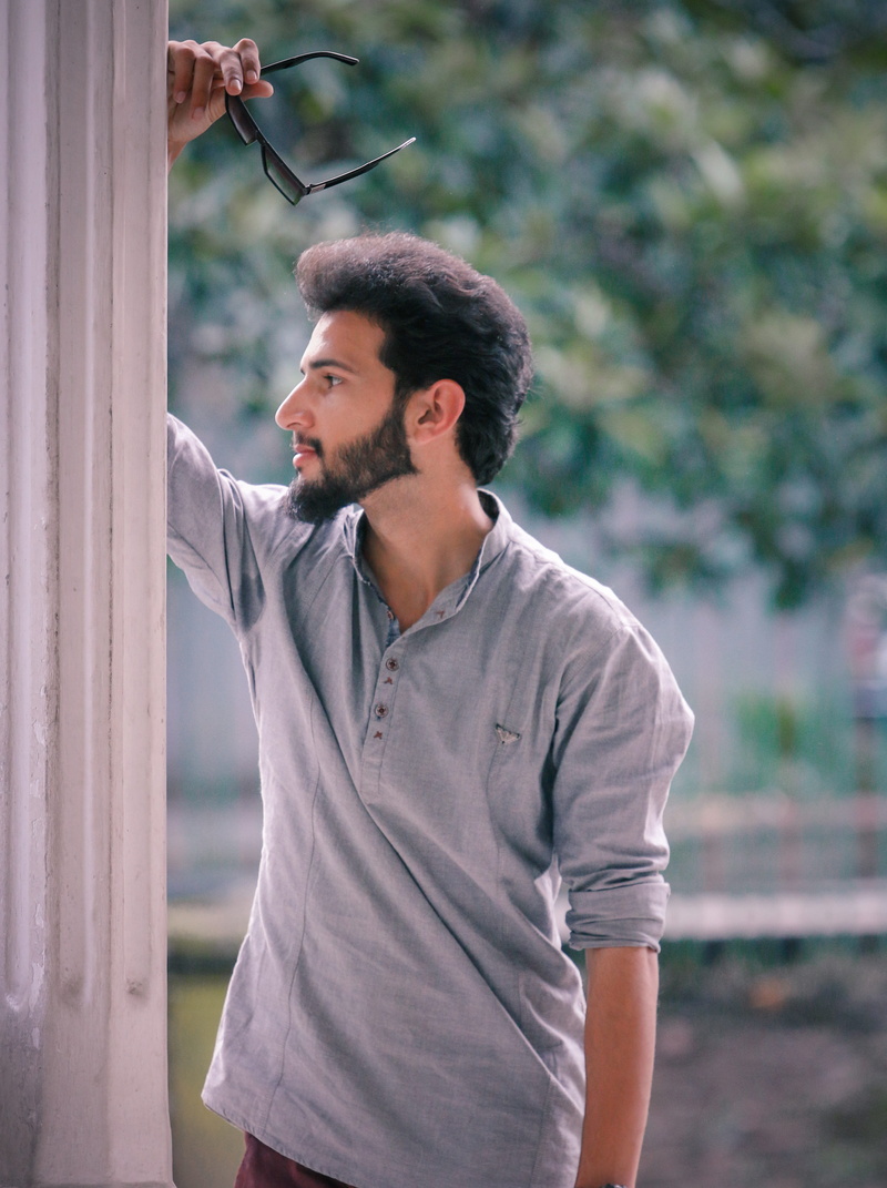 male model, stylish, lifestyles, fashion, outdoors, waist up, beard, standing, looking away, contemplation, boys fashion, hair style, shoes, attractive