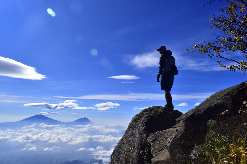 one person, nature, leisure activity, scenics - nature, adventure, cloud - sky, outdoors, blue, rock - object, real people, mountain peak, rock, tranquil scene