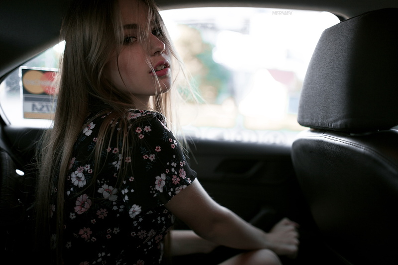depth of field, open mouth, looking at viewer, dress, hair in face, inside a car, 2K, portrait, women with cars, Artyom Mernaev, car, vehicle interiors