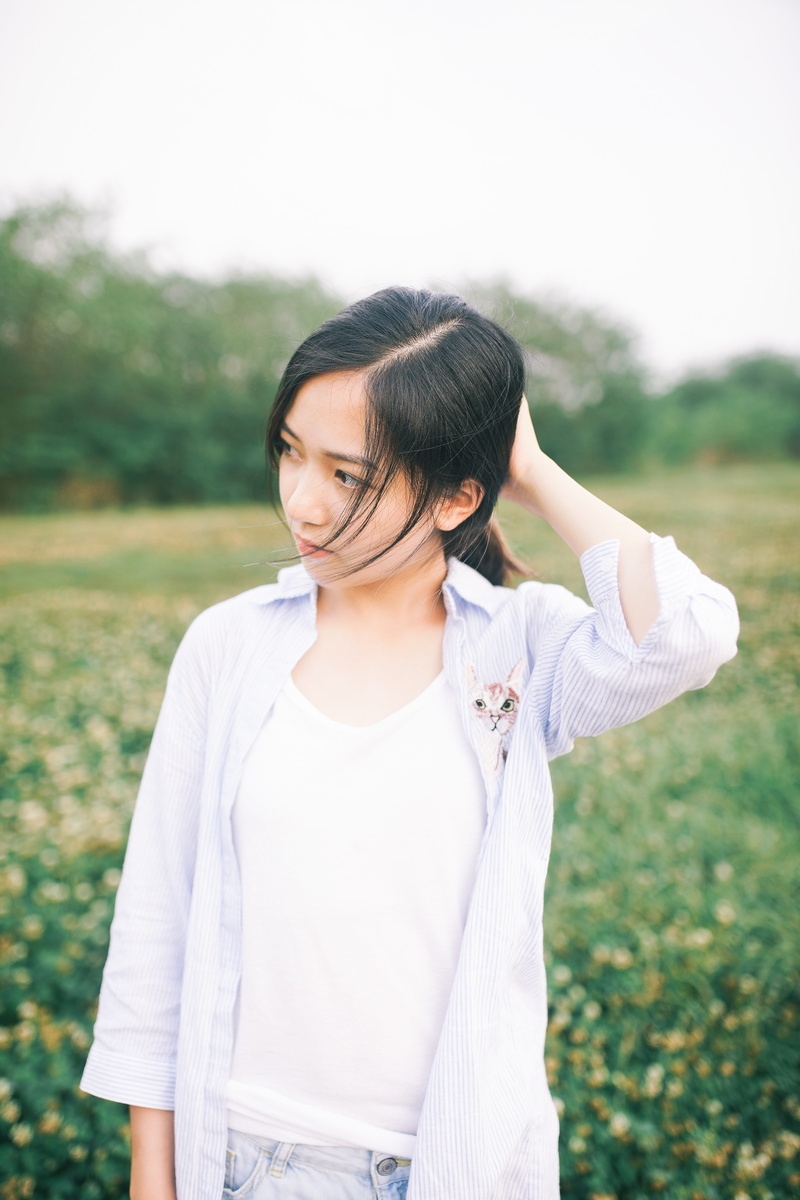black hair, outdoors, chinese, behind, lifestyles, young, person, holding, outdoor, grass, one person, china, dress, standing, cat, young adult, green