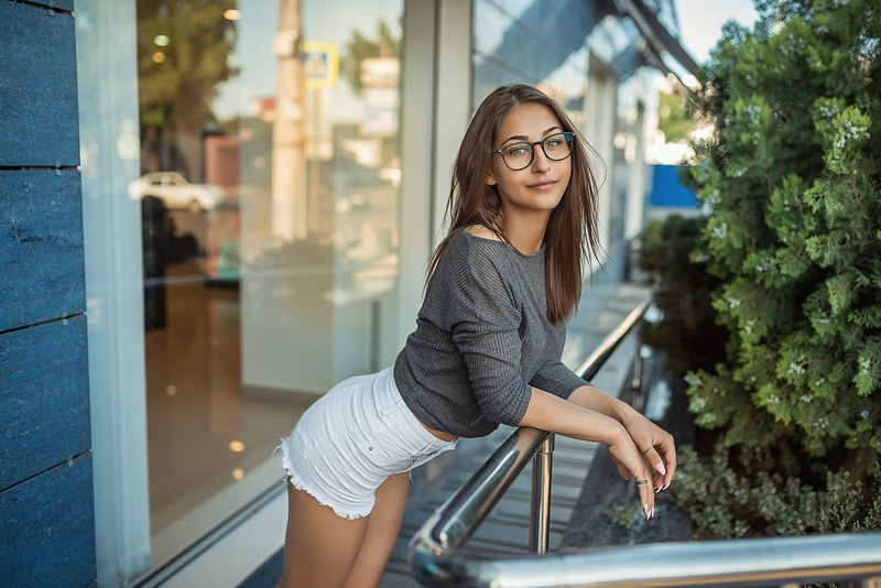 high waisted short, adult, young adult, fashion, glasses, petite, women with glasses, women, portrait, tanned, outdoors, one person, depth of field, eyeglasses