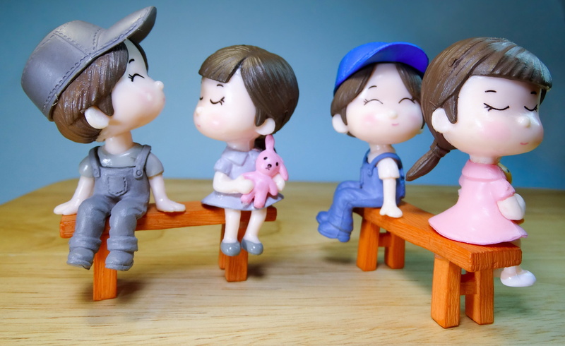 relationships, close-up, innocence, rejection, 4K, wood - material, table, blue, indoors, childhood, child, figurine, male likeness, styling, human representation