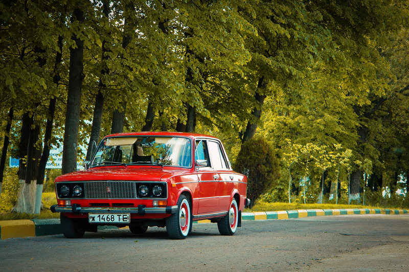 red, motion, sedan, 2103, street, land vehicle, incidental people, classic, outdoors, road, day, nature, motor vehicle, tree, on the move, mode of transportation