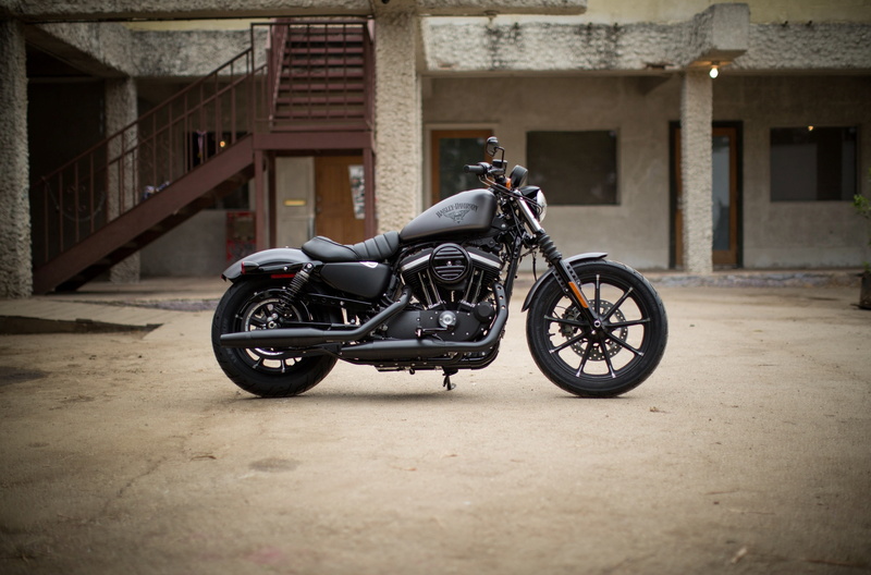 motorcycle, parking, building, built structure, city, stationary, mode of transportation, building exterior, architectural column, land vehicle, travel