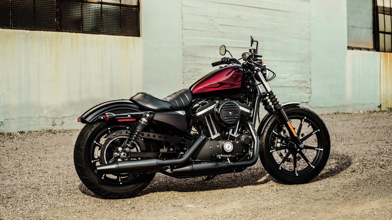 wall - building feature, land vehicle, city, mode of transportation, sunlight, motor scooter, Motorcycle, Iron 883, side view, transportation, building exterior