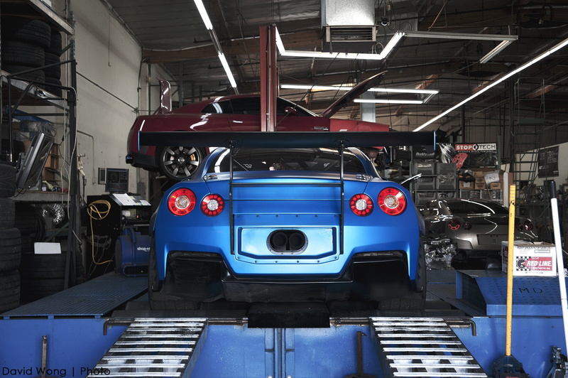 occupation, train, technology, machinery, car, stationary, land vehicle, Nissan GT-R, indoors, shopping, architecture, Nissan, transportation, garage, vehicle