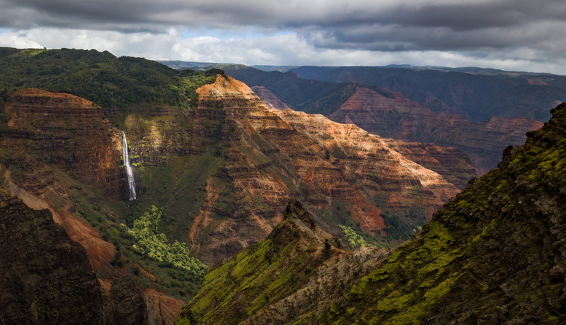 rock, no people, cloud - sky, waterfall, travel destinations, canyon, tranquility, mountain range, overcast, rock - object, non-urban scene, environment