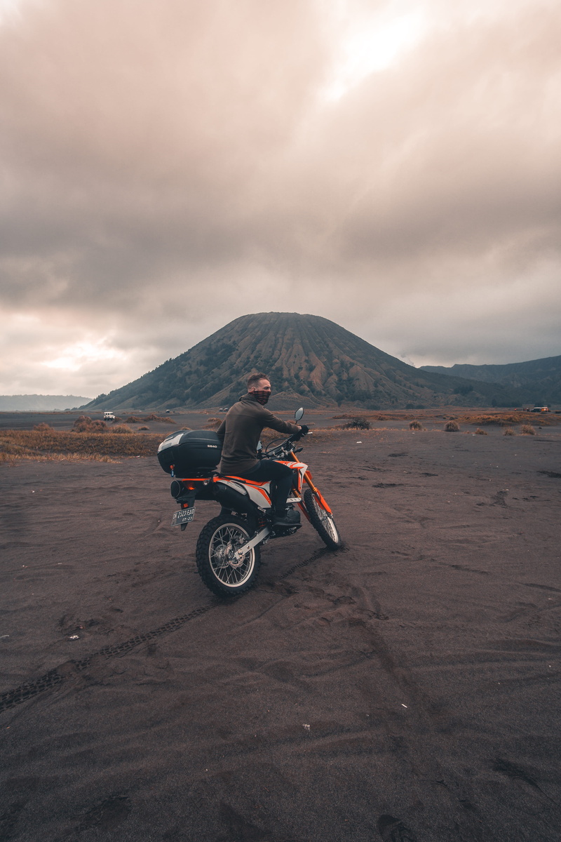indonesia, cloud - sky, transportation, java, one person, mt bromo, full length, outdoors, 5K, crash helmet, land vehicle, vehicle, sky, orange, man, mountain